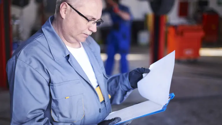 man in blue coat doing an inspection